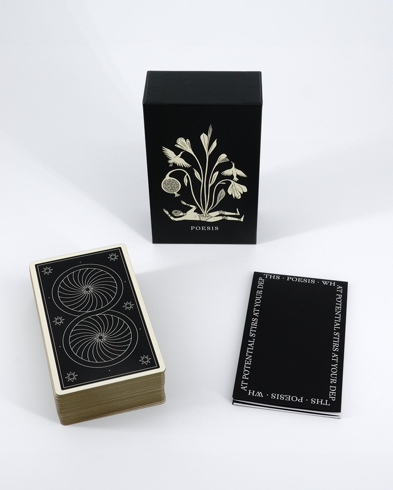 A Poesis Oracle deck with its box and instruction sheet displayed. The box is black with gold design elements, and the cards have gold-gilt edges.