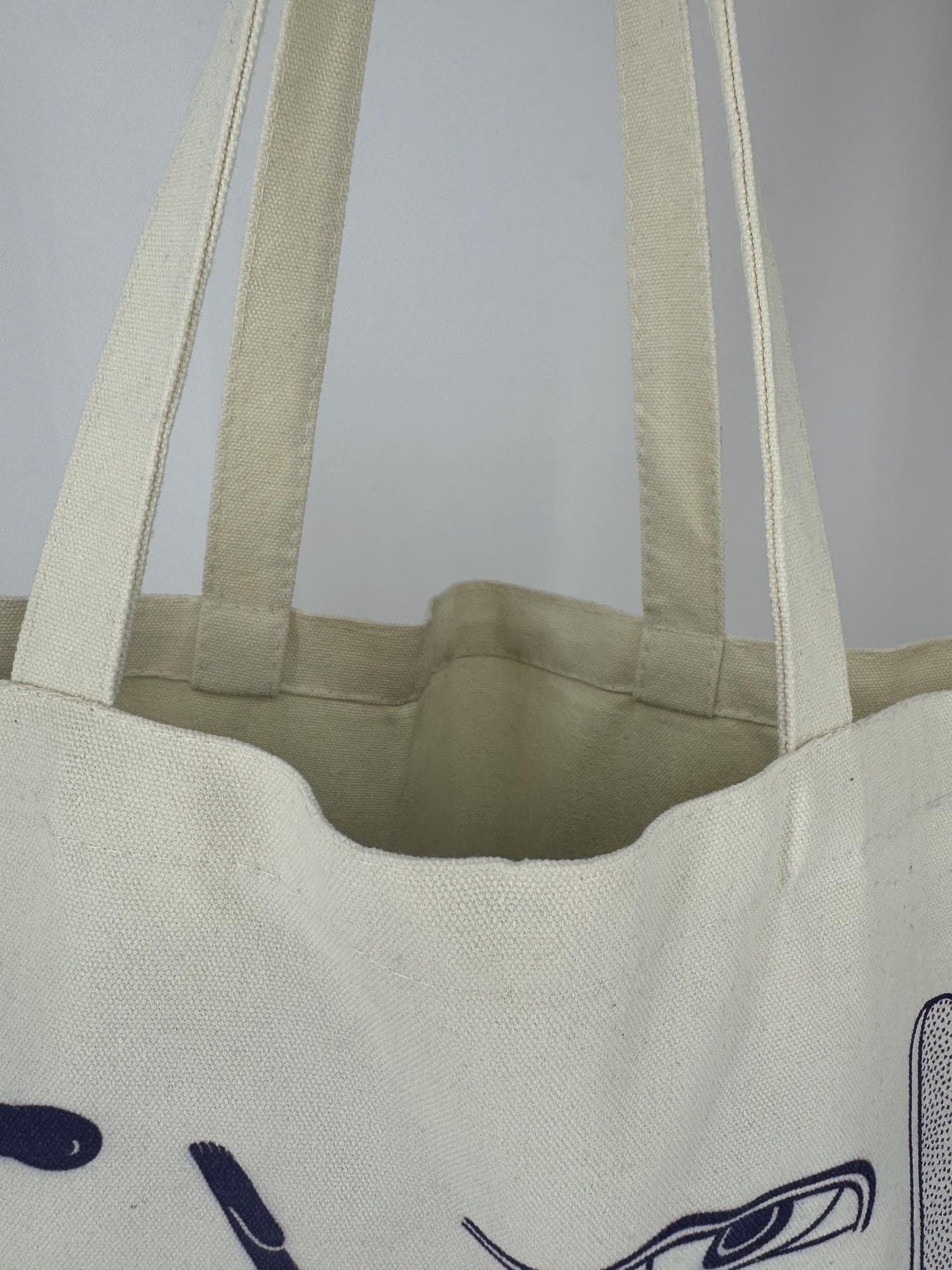 a close up of a canvas totebag showing the details.